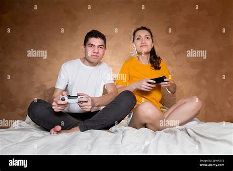 Brother and sister fight in a video game on a game console using ...