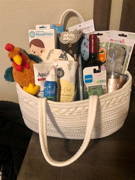 A White Basket Filled With Baby Items On Top Of A Table