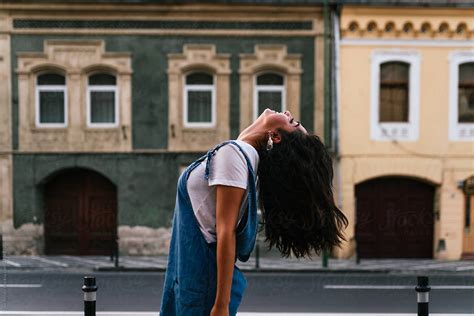 Pretty European Woman Shaking Her Hair On Wind By Stocksy