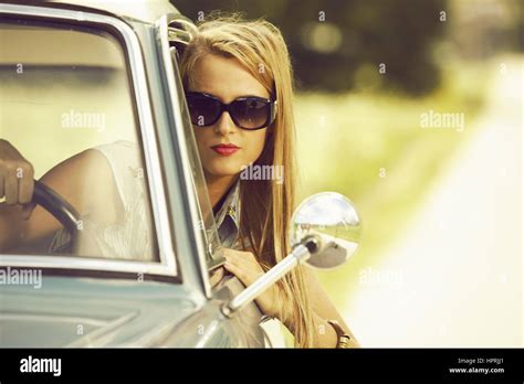 Young woman driving vintage car Stock Photo - Alamy