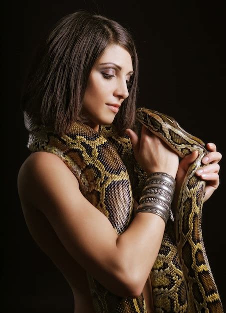 Premium Photo Sexy Brunette Holding Python Over Black