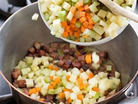 Two Bowls Filled With Chopped Vegetables On Top Of A Stove