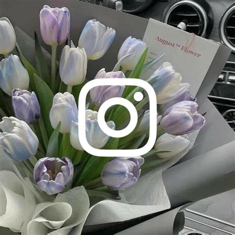 A Bouquet Of Tulips Sitting On Top Of A Car Dash Board With The