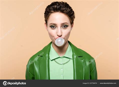 Trendy Brunette Woman Blowing Bubble Gum While Looking Camera Isolated Stock Photo