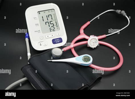 Blood Pressure Meter Stethoscope And Thermometer On Black Background