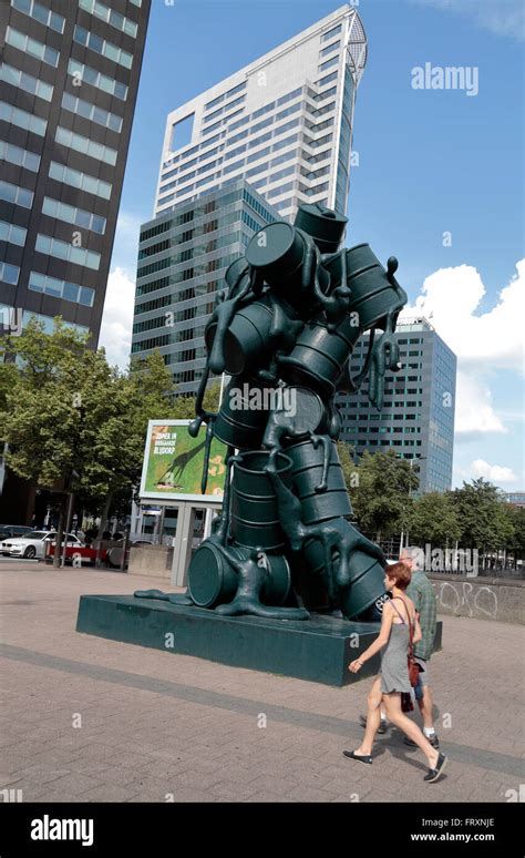 A Couple Walk Past Cascade A Sculpture Of Oil Barrels By Atelier Van