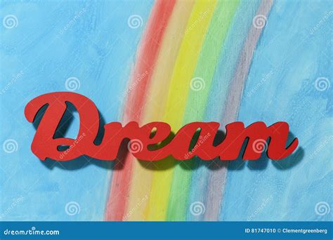 The Word Dream With A Colorful Rainbow And Blue Sky Background Stock