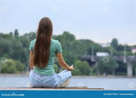 Teenage Girl Meditating Near River Space For Text Stock Photo Image