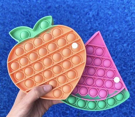 Two Waffles Shaped Like Fruit Are Being Held By A Person S Hand