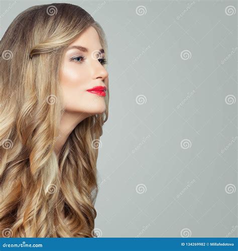 Perfect Blonde Model Gorgeous Woman With Long Healthy Curly Hair And Red Lips Makeup Stock