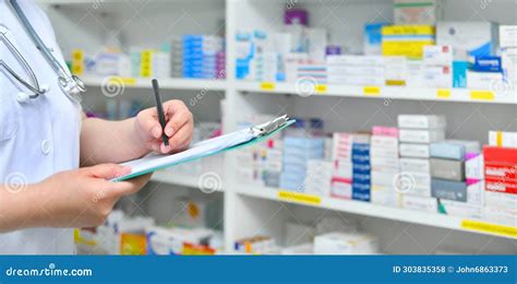 Pharmacist Filling Prescription In Pharmacy Drugstore Stock Photo