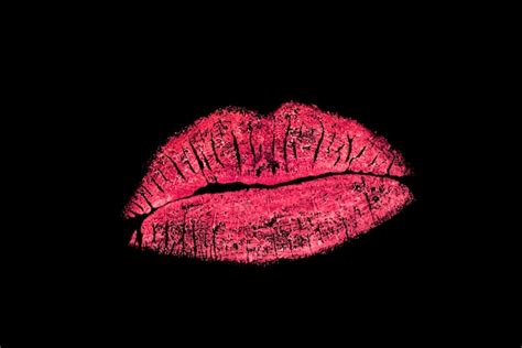 Premium Photo | Vivid red lipstick kiss mark on black background