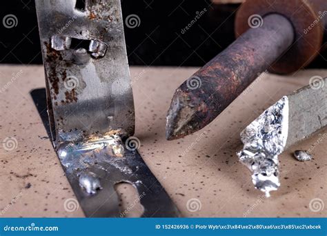 A Large Soldering Iron And Soldering Accessories On A Workshop Table