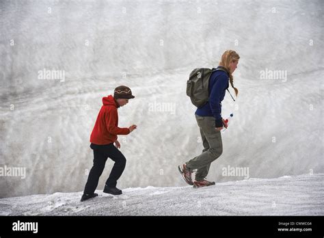 Mother And Daughter On Snowy Hillside Stock Photo Alamy