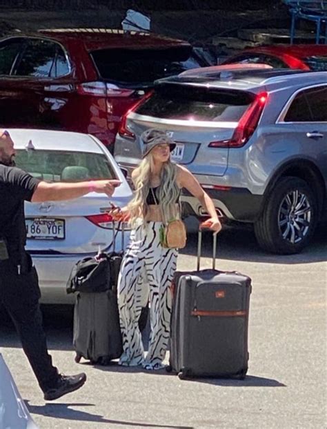 a man standing next to a woman with luggage