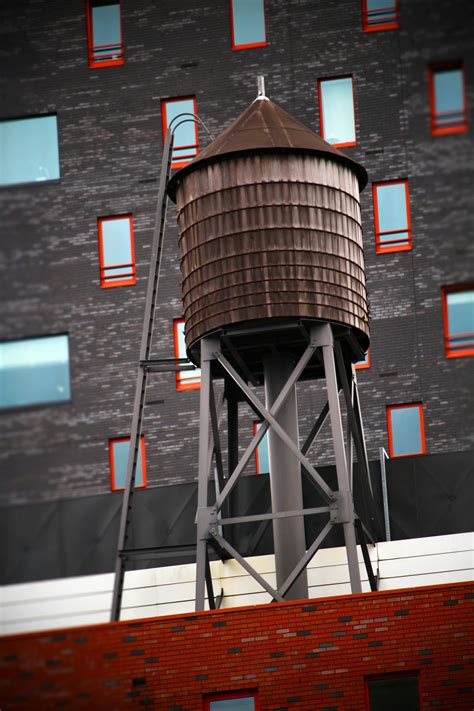 Brown Water Tower On Rooftop · Free Stock Photo