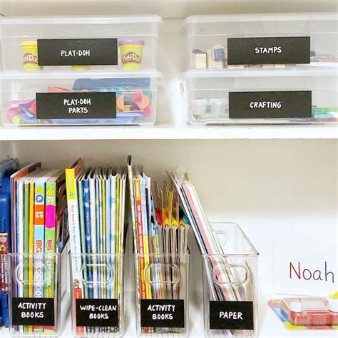 The Shelves Have Clear Bins With Labels On Them And Plastic Containers