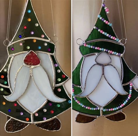 Two Stained Glass Christmas Tree Ornaments Hanging From Strings And