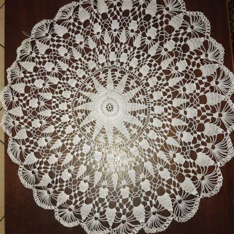 A White Doily Is Sitting On A Brown Table