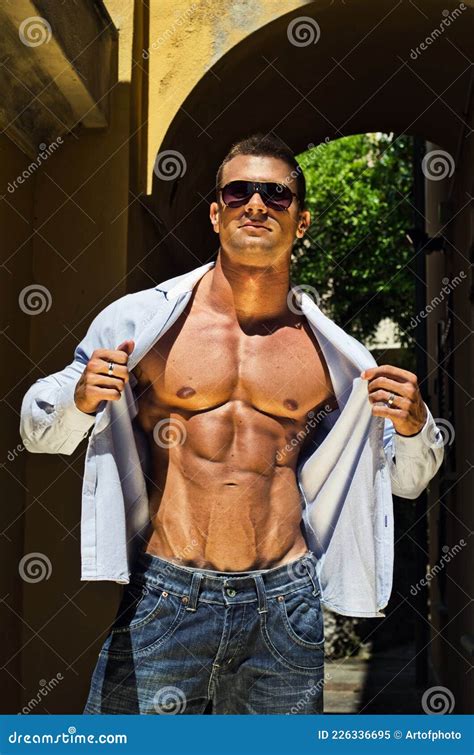 Attractive Young Muscle Man Outdoors Holding Shirt Open Stock Image