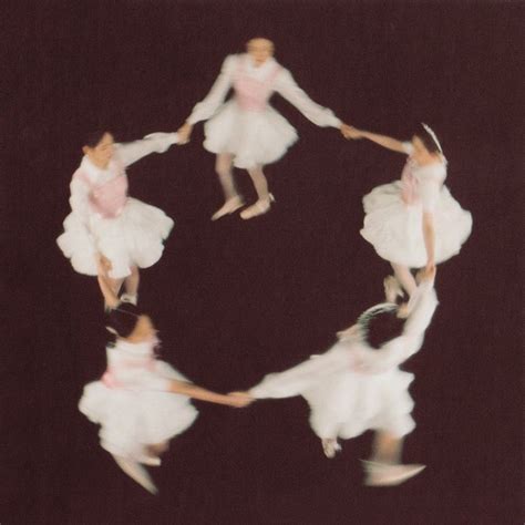 Four Ballerinas In White Tutus Are Spinning Around On Their Feet And