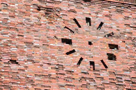 Abandoned Old Vintage Red Brick Wall With Round Clock On Facade