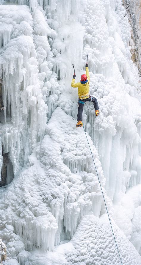 Male Ice Climber Ascending On Frozen Waterfall By Stocksy Contributor