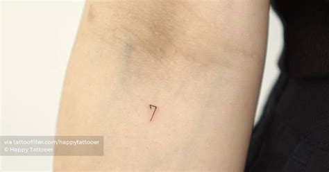 Tiny tattoo of the number "7" done on the inner