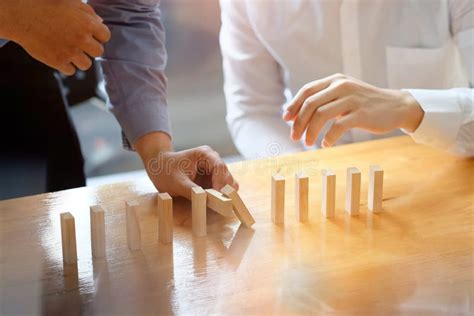 Businessman Two Colleagues Hand Stopping The Domino Effect Risk Stock