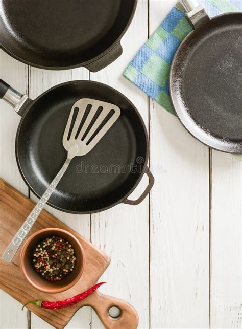 Several Empty Cast Iron Frying Pans On A White Wooden Background Mix