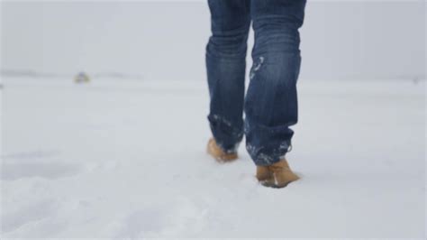 Man walking in snow. Man walking on snow, footprints in snow, behind ...