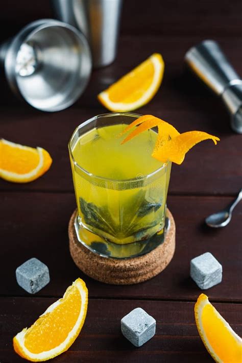 Whiskey Cocktail In Glass With Natural Cube Stones And Orange Peel Jagger And Shaker At