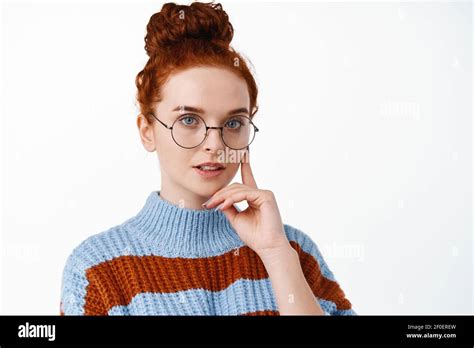 Portrait Of Young Thoughtful Redhead Woman In Glasses Having Her Hair