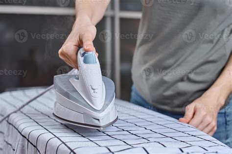 Woman ironing clothes on the ironing board with modern iron 14264673 Stock Photo at Vecteezy