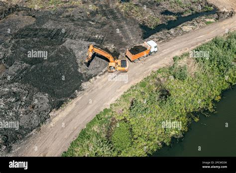 Aerial View Of An Backhoe And Truck On Earthworks Marshy Area