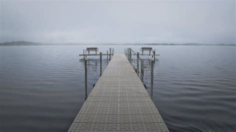 Dock With Benches On Foggy Lake In Bemidji Minnesota Stock Photo