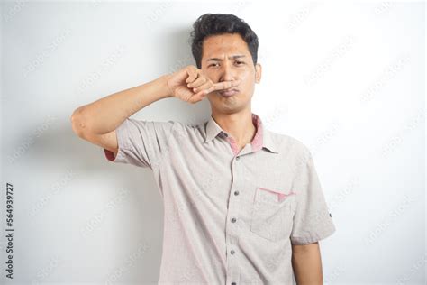 Portrait Of Disgusted Man Pinches Nose With Fingers Hands Looks With