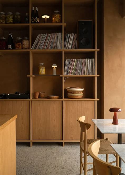 A Room With Shelves Chairs And Tables In Front Of The Counter Top Is