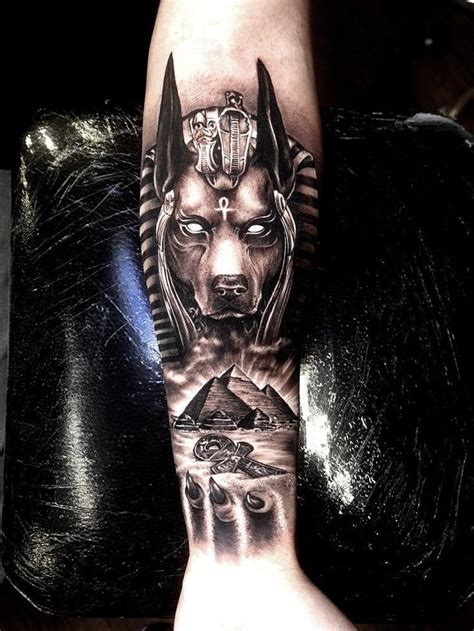 A Man S Arm With An Egyptian Mask And Pyramids On The Cover Up