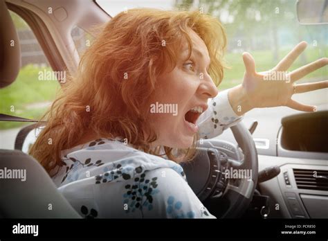 Angry Woman Driver Screaming And Gesturing While Driving A Car