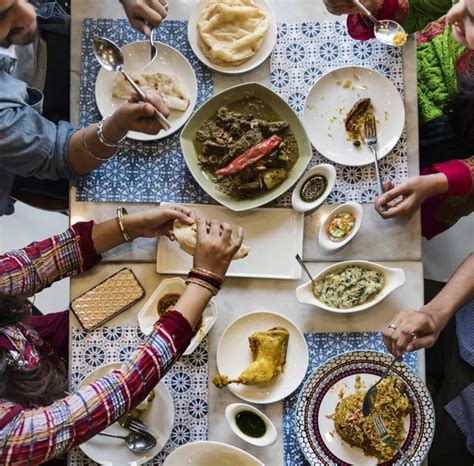 People eating Indian Food in restaurant — Stock Photo © Rawpixel #131785792