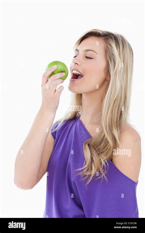 Blonde Woman Eating A Green Apple Stock Photo Alamy