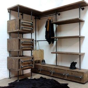 A Coat Rack With Drawers And Clothes Hanging On It S Sides Next To A