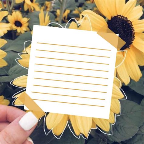 Someone Holding Up A Piece Of Paper With Sunflowers In The Background