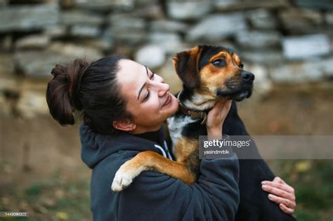 Dog Loved And Kissed By Young Beautiful Female Owner Outdoors Dog Love