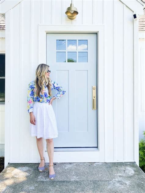 A Woman Standing In Front Of A White Door