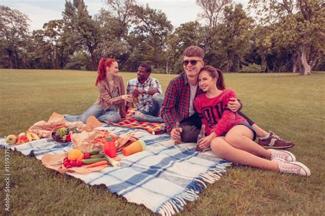 Image of happy couples having picnic in park all together. Cheerful and ...