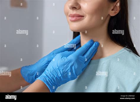 Endocrinologist Examining Thyroid Gland Of Patient Indoors Closeup