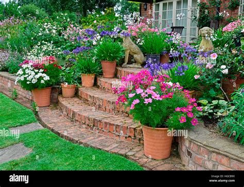 Colourful Garden Terrace With Mixed Flower Beds And Planted Containers