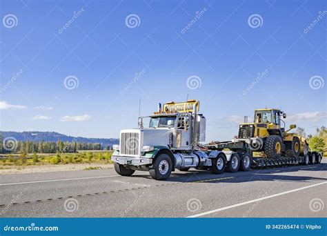 Powerful White Day Cab Big Rig Semi Truck With Oversize Load Sign On